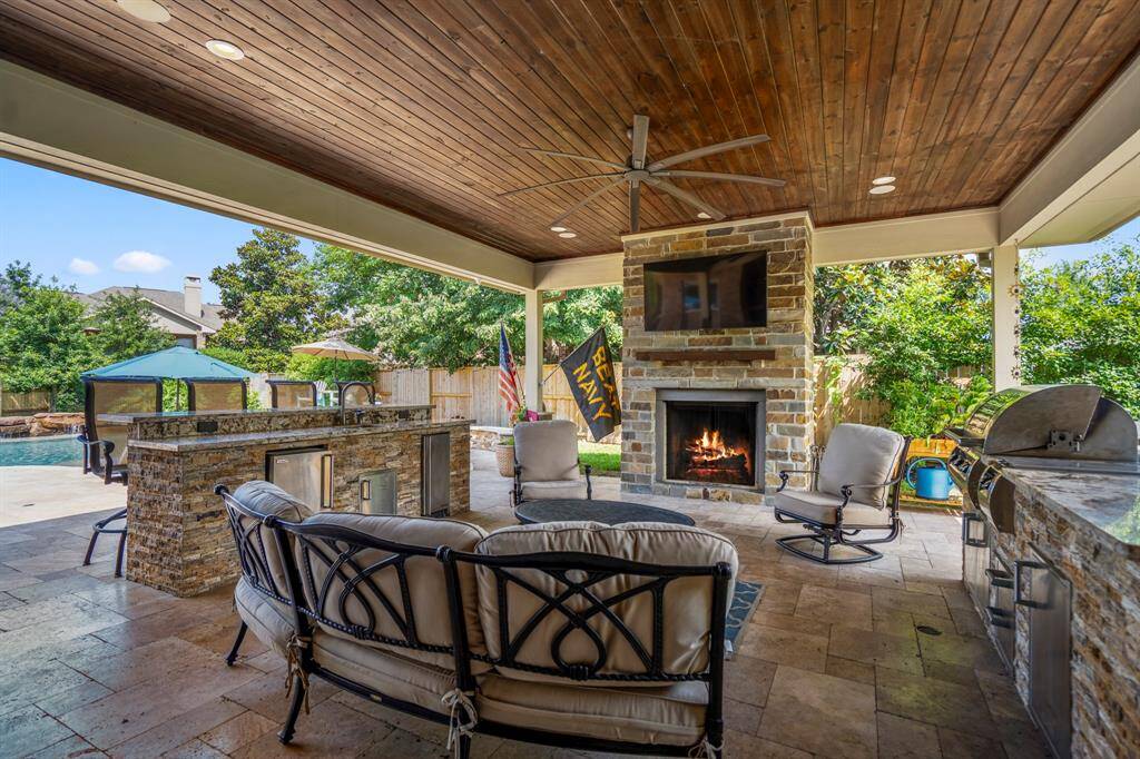 This well-designed outdoor kitchen and fireplace works together with its indoor counterpart when cooking or entertaining guests and complements a home's architecture and landscaping.