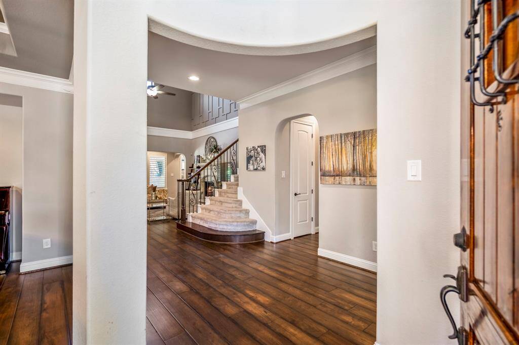 Invite your guests into your new home through a wood speakeasy front door into a grand foyer area, complete with gleaming large plank hardwood floors that offers a warm welcome.