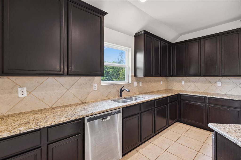Undermount kitchen sink with window view of backyard