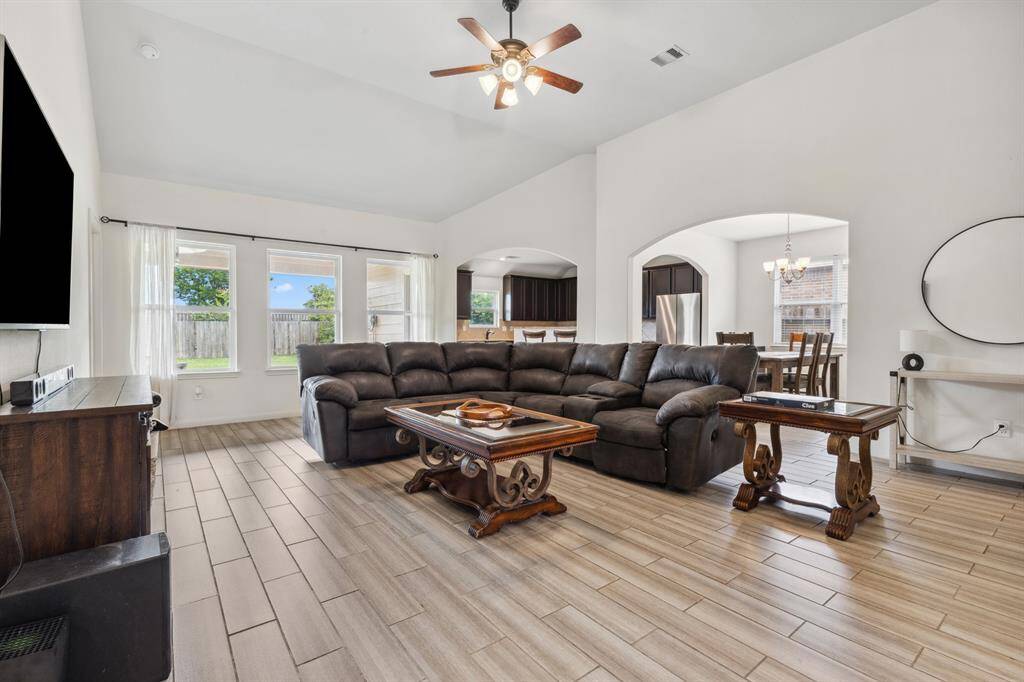 Wall of windows with views of covered patio and backyard; Enjoy the taller ceilings
