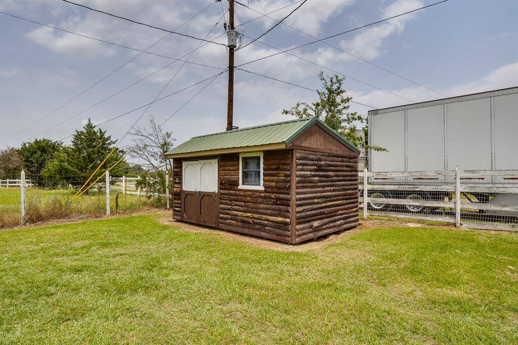 Rustic log-style shed with metal roof—ideal for extra storage, workshop, or creative retreat.