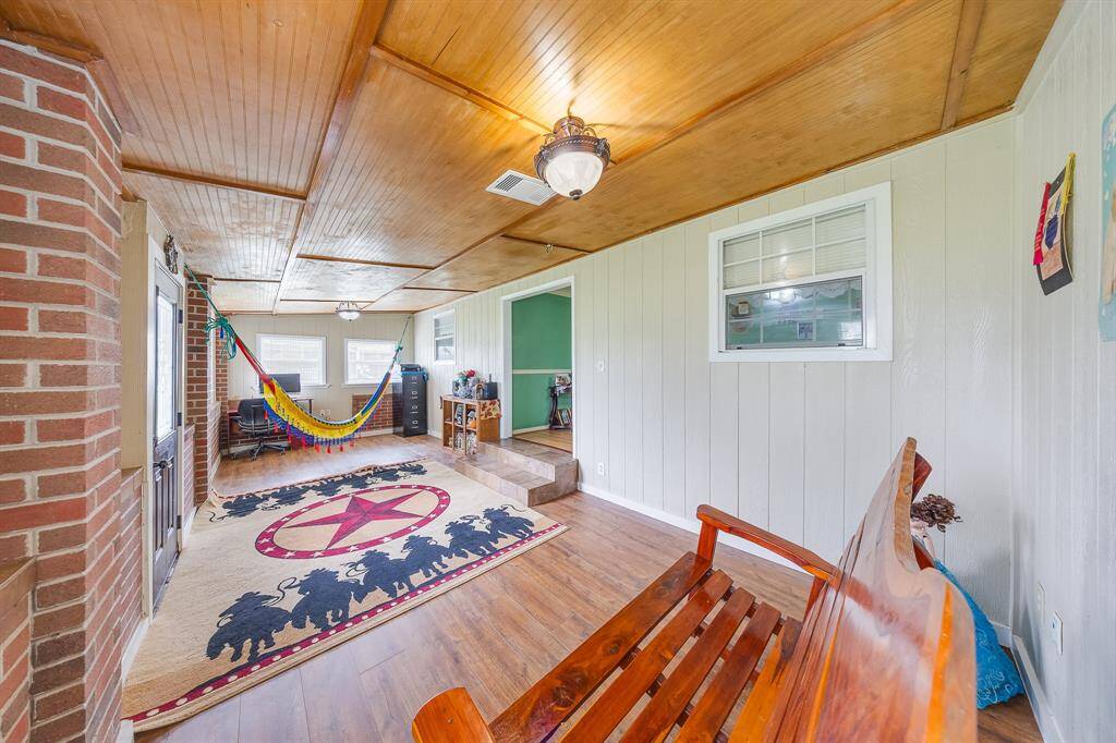 Charming wood-ceiling room with step-up entry, bright windows, and peaceful vibes—perfect for relaxing or entertaining.