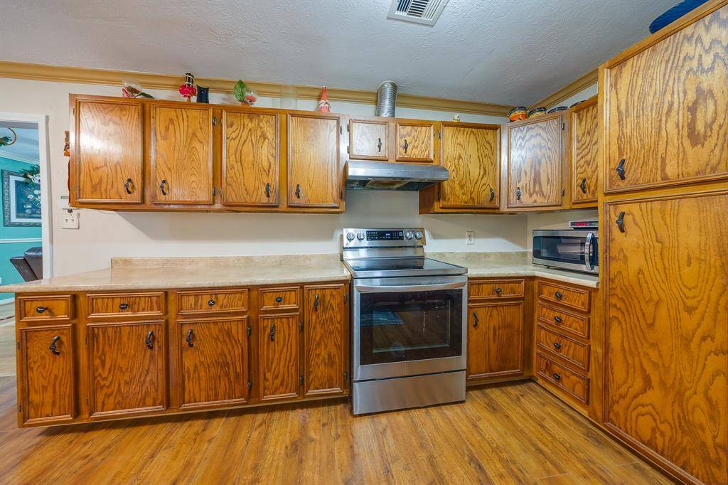 Classic kitchen with wall-to-wall cabinets, stainless steel stove, and plenty of prep space for everyday meals.