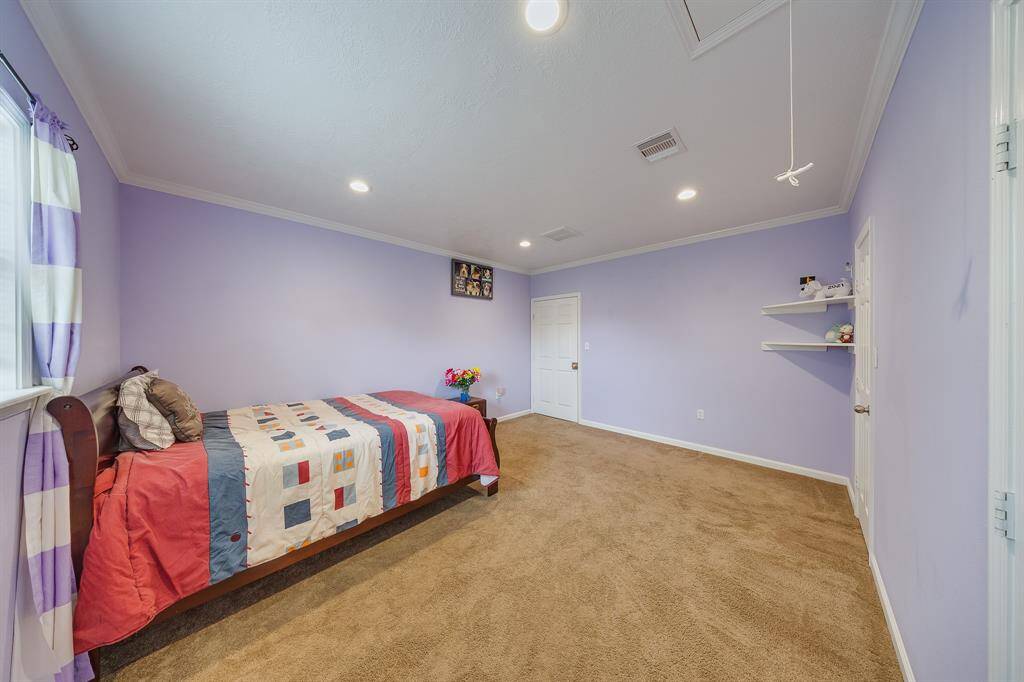 Second view of the bedroom shows natural light, cozy setup, and functional storage—great for kids or guests.