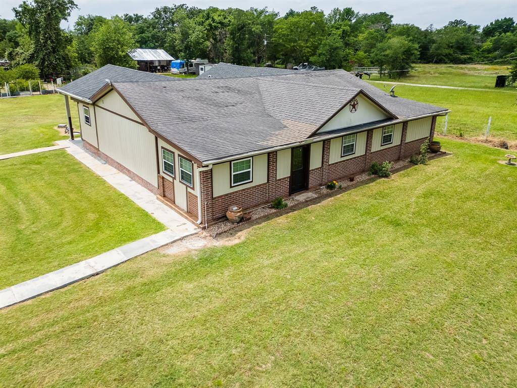Front-right exterior shot highlighting the brick and siding combination and well-kept landscaping.