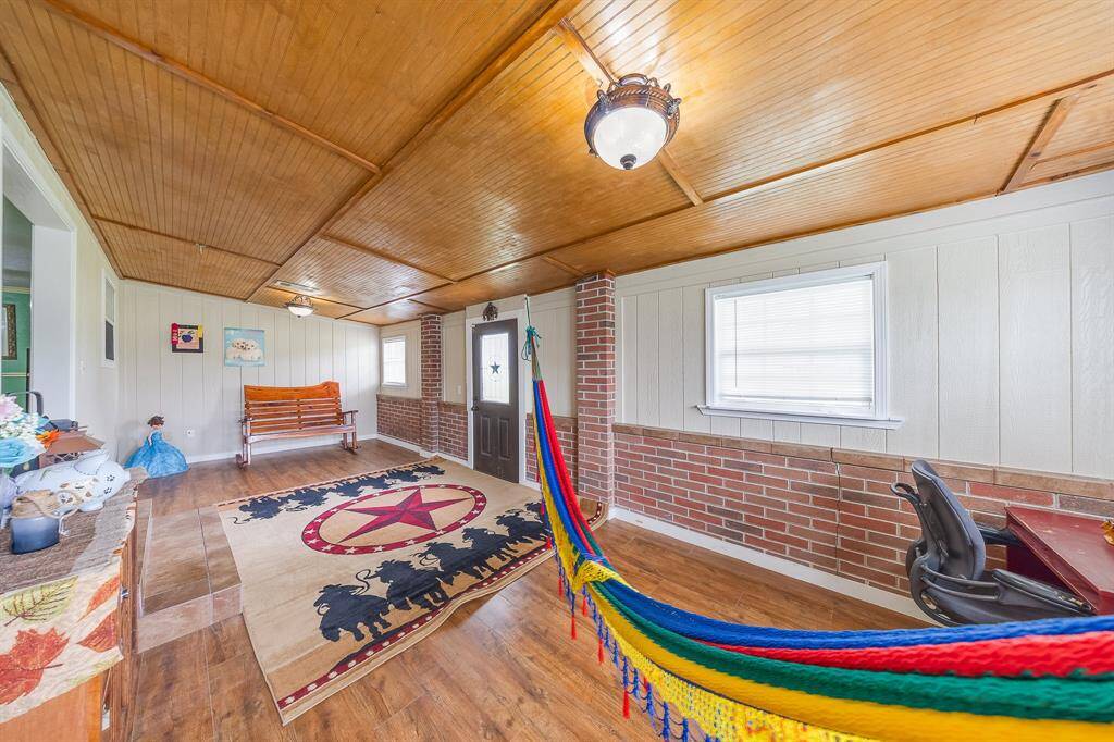 Multi-use space with front door access, workstation, and hammock—great as an enclosed porch or flexible bonus room.