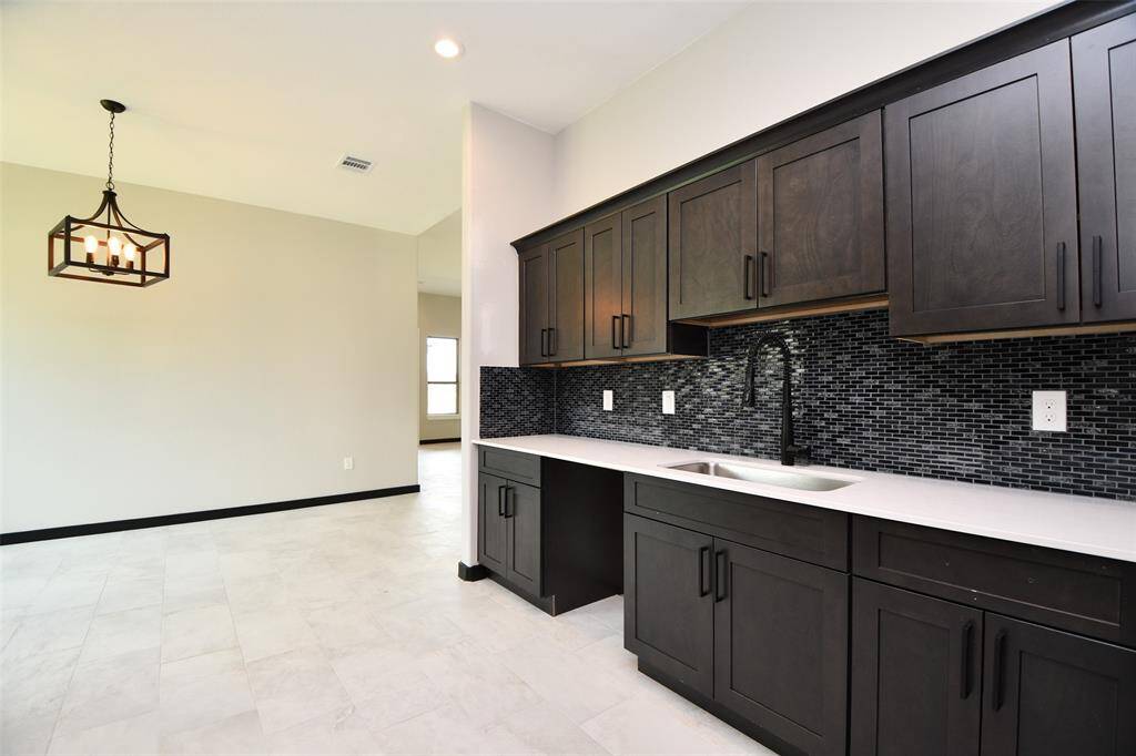 Kitchen has appealing backsplash and Cabinets / Counterspace galore