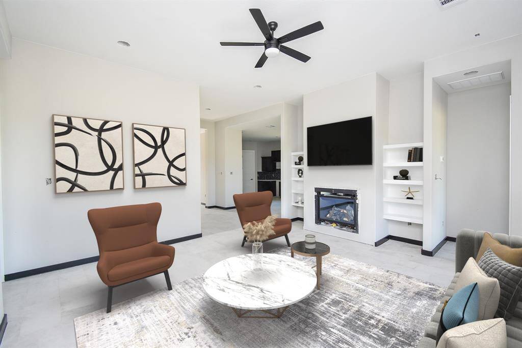 Family Room is huge with a fireplace and built-in shelves. Virtually Stage Image