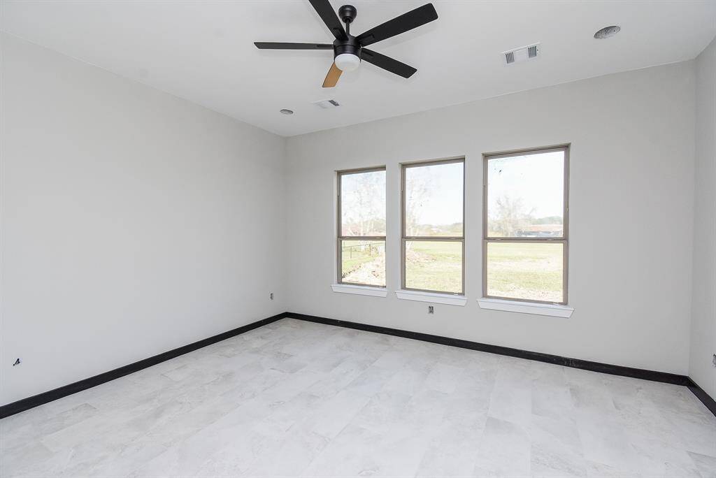 Primary Bedroom has lots of natural lighting with a view to the acreage out back.