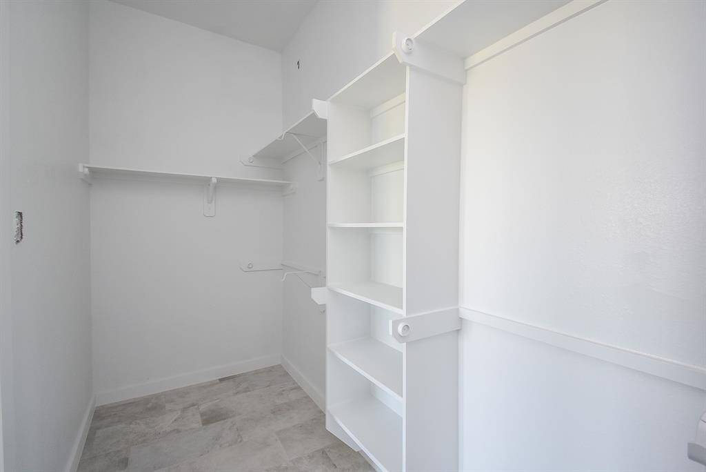 Primary Bedroom Closet has shelving and built-ins
