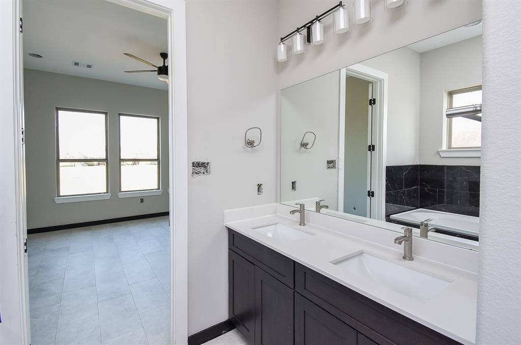 Bedroom 2 is spacious with ceiling fan. Virtually Staged Image