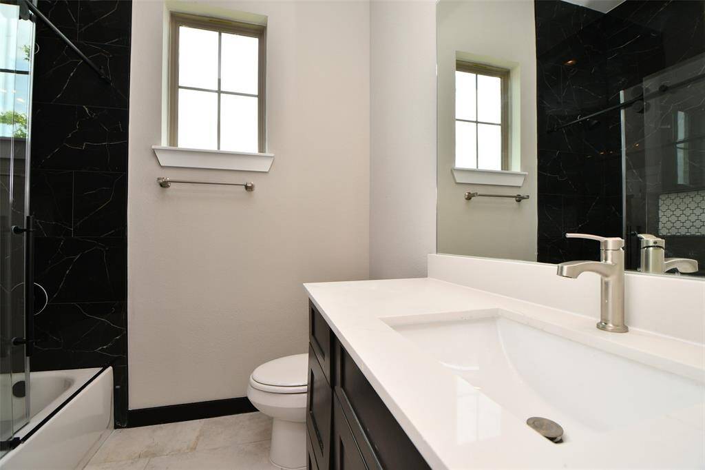 Secondary Bath large shower with floor to ceiling tiling.