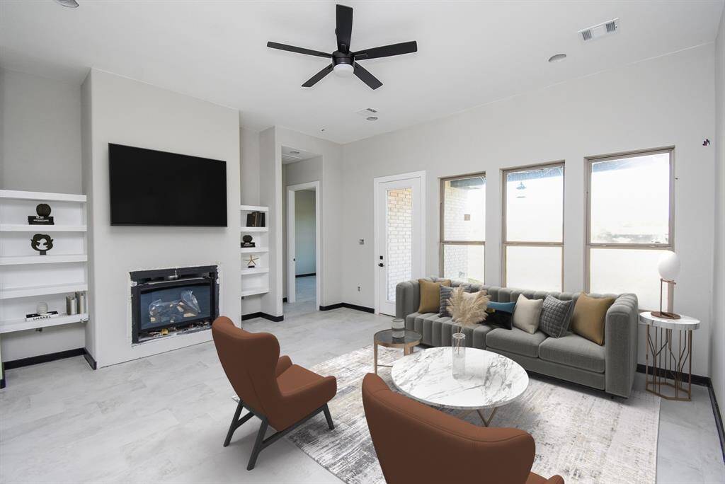 Family Room is huge with a fireplace and built-in shelves. Virtually Stage Image