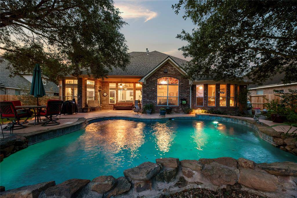 Welcome to this sparkling pool home nestled lakefront - all that is missing is you!