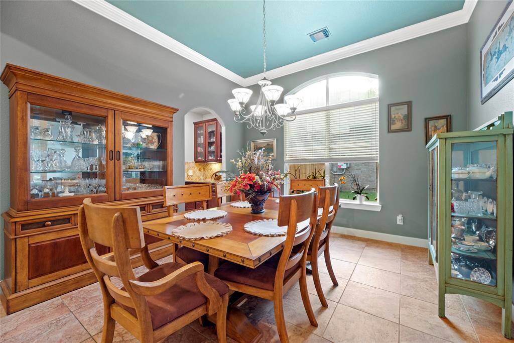 The crown molding adds the hint of elegance that bursts through the dining room. The shades of wall paint embrace and produce warmth throughout the home.