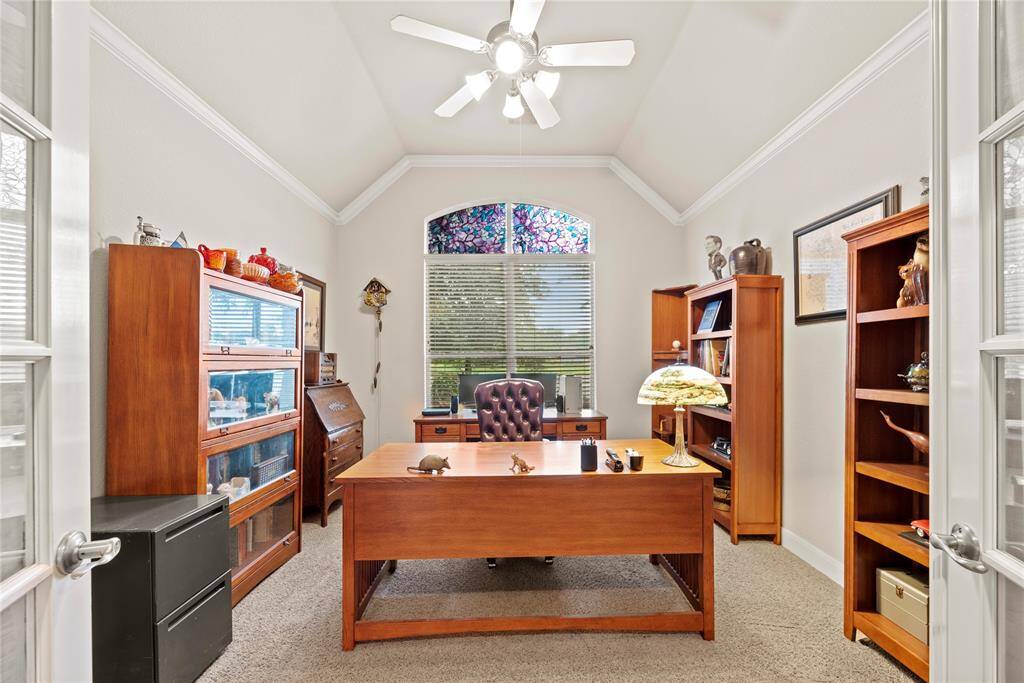 With a workspace so alluring, you might be more productive. Lovely french doors add privacy and sophistication to this study.