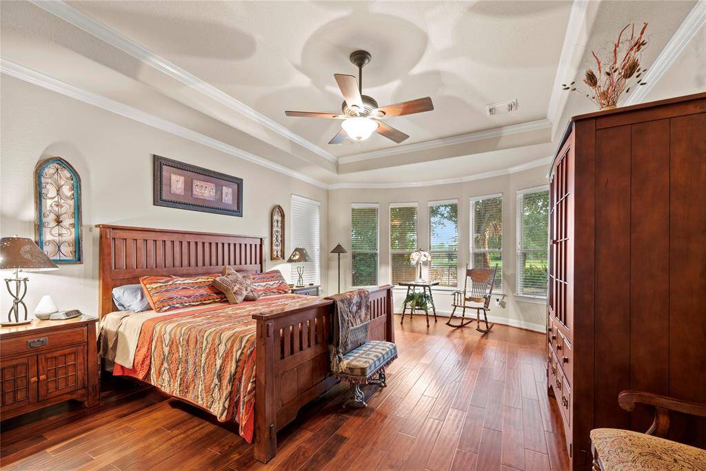 This spacious owner’s retreat is a beautiful space to begin and end your day. A wall of windows allows natural light to pour in - making for a welcoming and inviting primary suite.