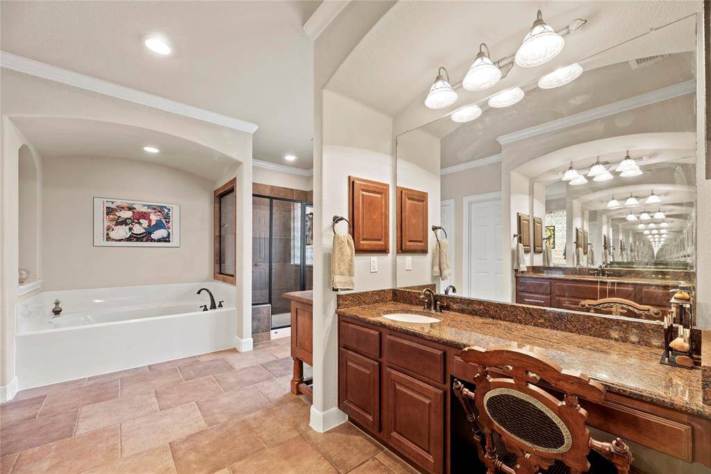 The owner’s ensuite bathroom features dual sink vanities with granite countertops, full mirrors, and a place to sit while you primp. You’ll have all the space you need to store all of the essentials here.