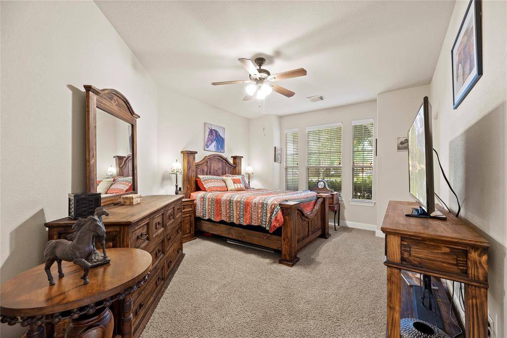 Stretch out and relax in cozy comfort in this secondary bedroom. The light pouring in from the windows makes the space bright and inviting.