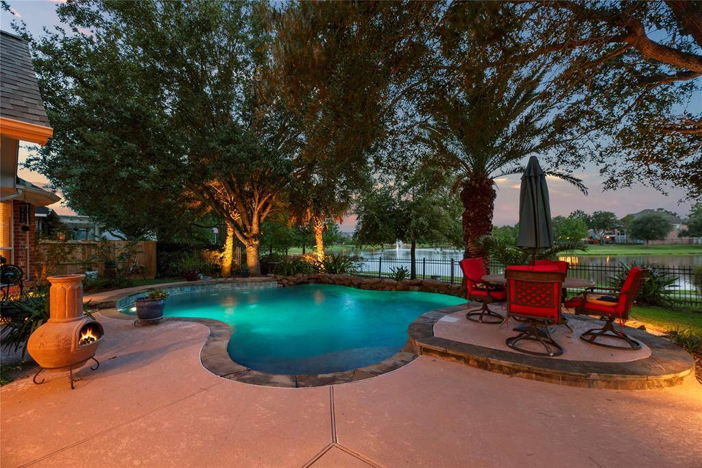 This pool-side paradise has ample space for a grill and seating for everyone.