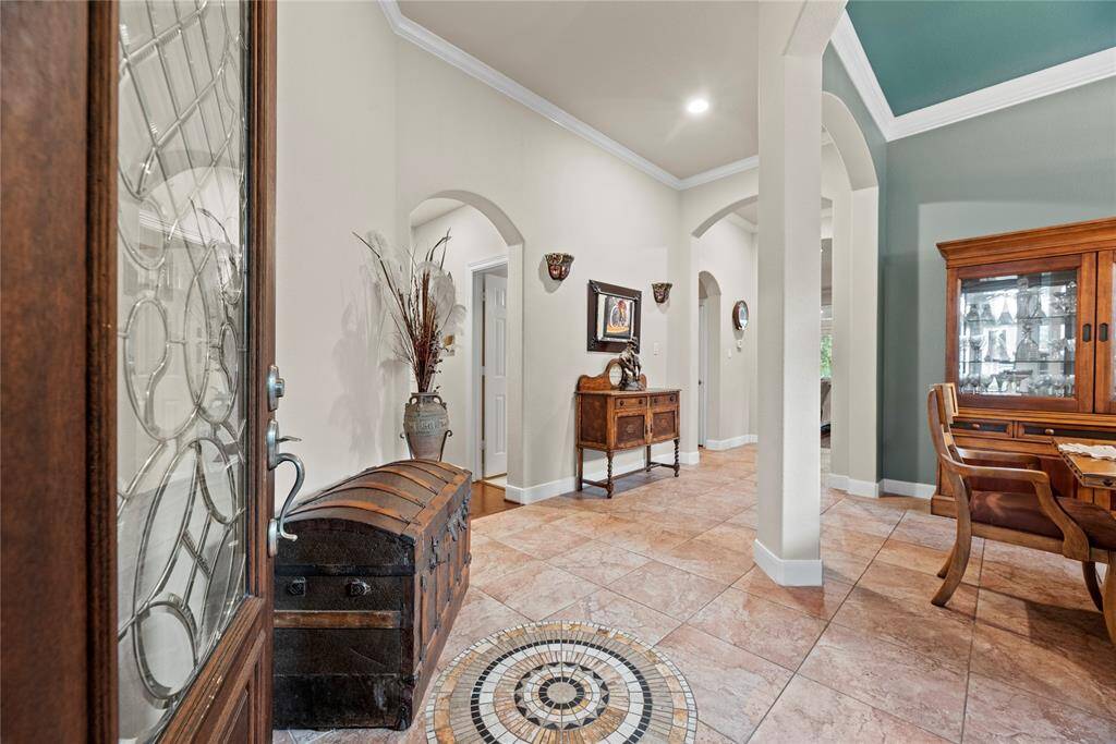 This house showcases its masterful design in the attention to detail. Notice the intricate designs on the front door, and the continuous arches throughout the house.