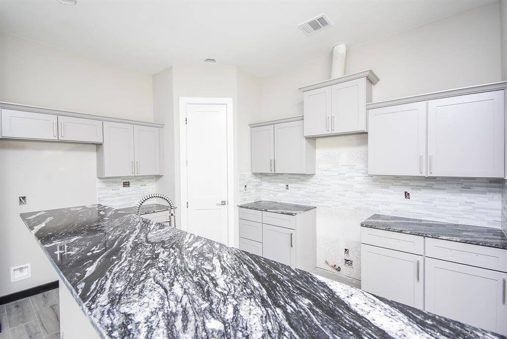 Island Kitchen with granite Counters and ample cabinet and counter space