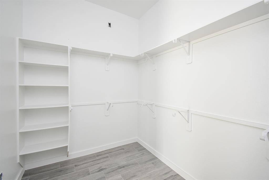 Primary Bedroom Closet with built-in shelves!