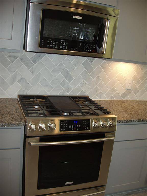 Stainless steel oven and microwave appliances with a gas stove top.