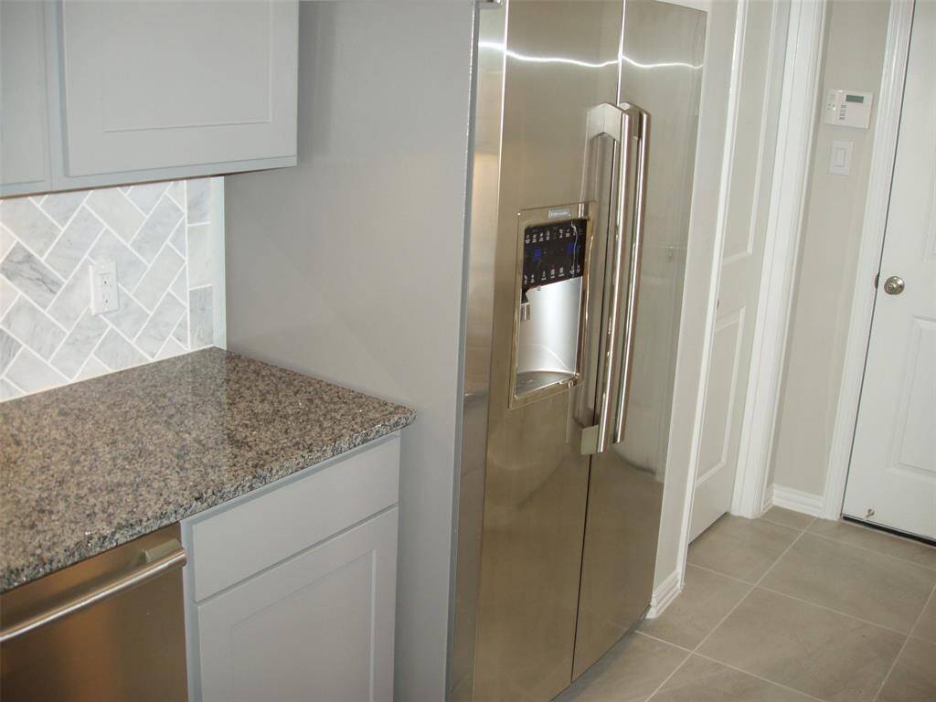 Large stainless steel refrigerator with ice maker included.