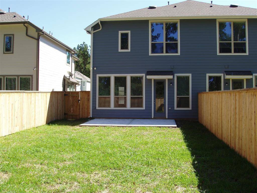 Large backyard and concrete patio, ready for a table and chairs.