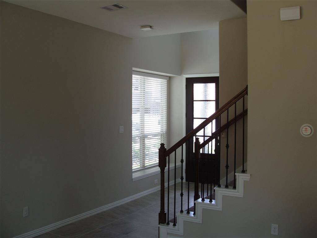 Front entry showing wrought iron railing. and window bench seat.