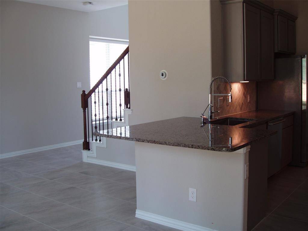 Floor tile throughout with open counter seating.
