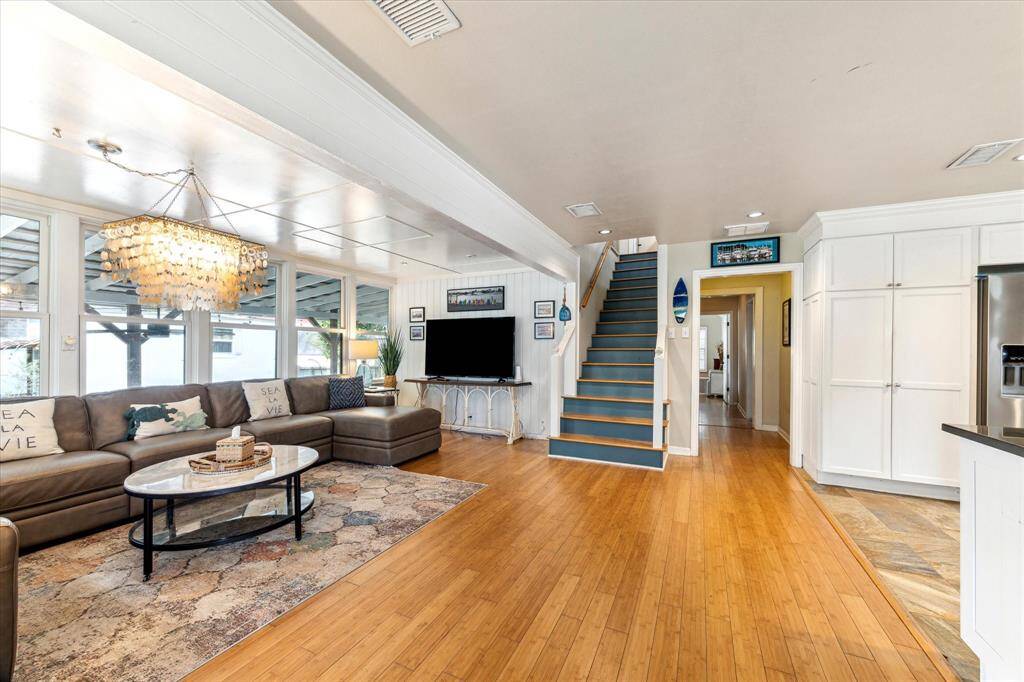 Living area is open to kitchen, hall leads to full bath, secondary bedroom, laundry room and primary suite.