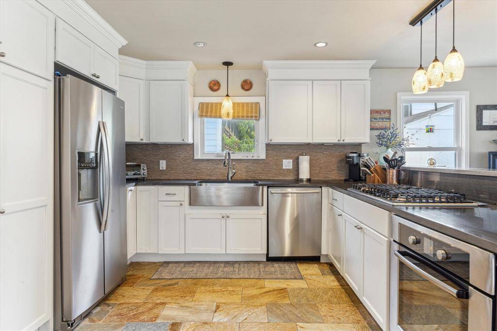 Stainless steel appliances and farm house stainless steel sink.