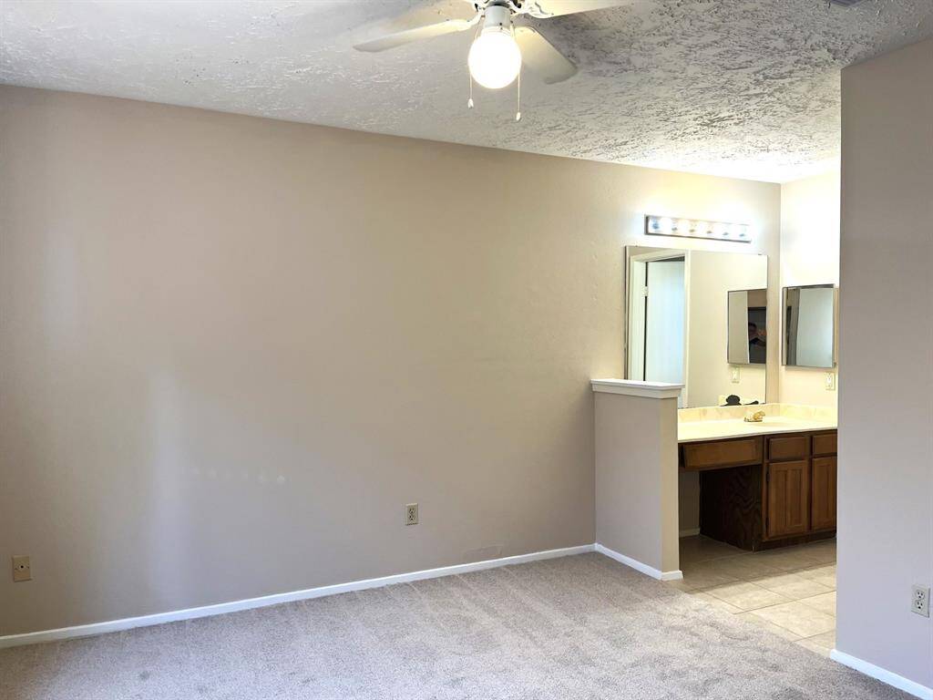 Here's the primary bedroom with its attached vanity area... there is also a separate toilet off this bedroom...