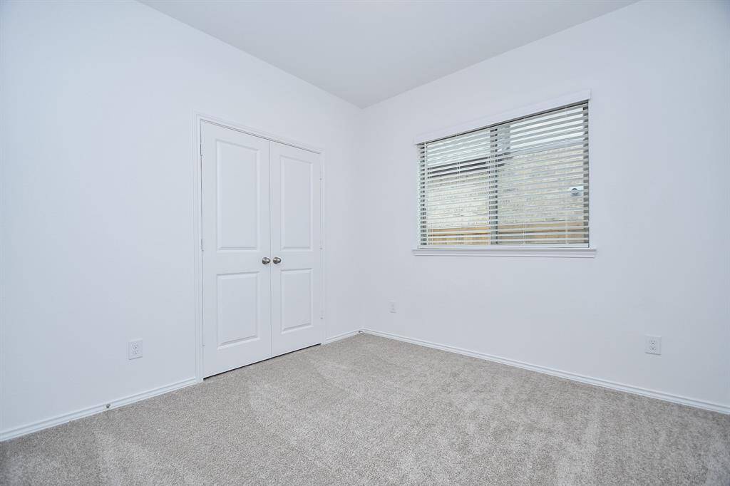 Whether family claims this secondary bedroom or it is reserved for guests, good closet space and bright natural light are guaranteed.