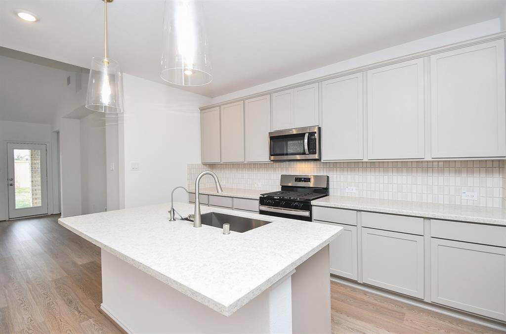 Tremendous counter space and wide, easy-to-navigate paths are a bonus to any tasking event! At left is the patio door leading to you own private patch of the greater outdoors.