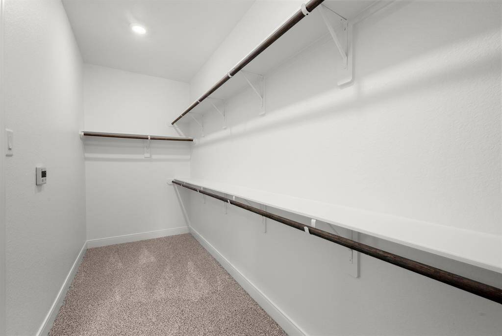spacious walk in closet located in primary suite