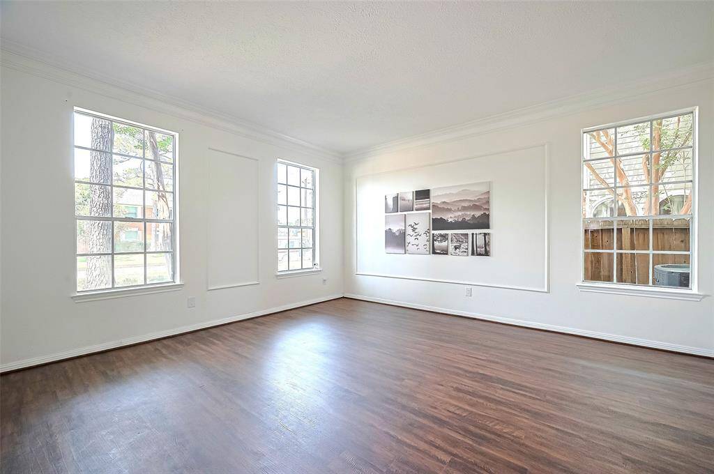 Expansive Living room featuring double crown molding, picture frame molding