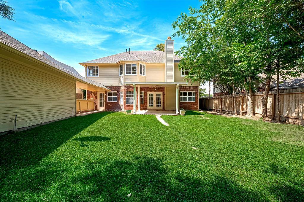 Spacious backyard perfect for kids to run, play, explore—plenty of room for outdoor adventures and family fun