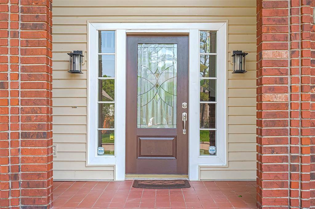 Beveled Front door elegantly complemented by a tiled front Porch