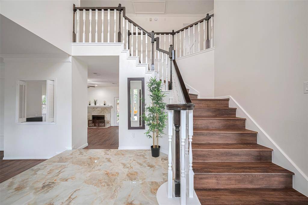 Grand Two Story Entrance featuring Luxurious Flooring & a Magnificent spiral staircase
