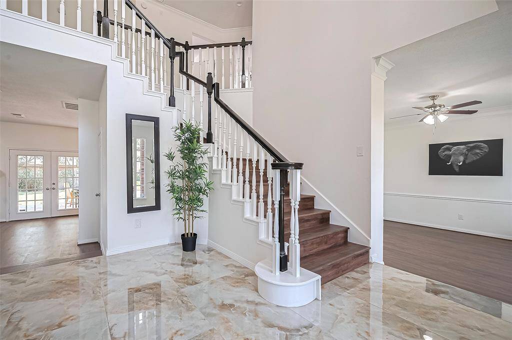 Magnificent spiral staircase adorned with an elegant wooden banister