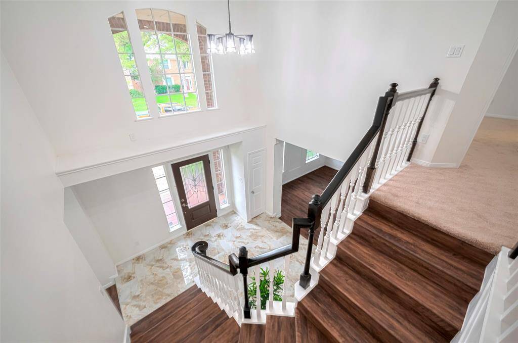 A soaring two-story ceiling with abundant windows, enveloping the space in warm, natural light