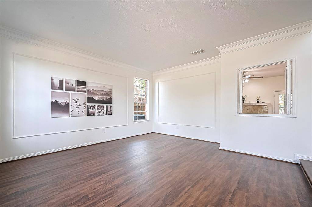 Spacious Living Room located to the left upon entering through the Foyer and have an opening to the dry bar