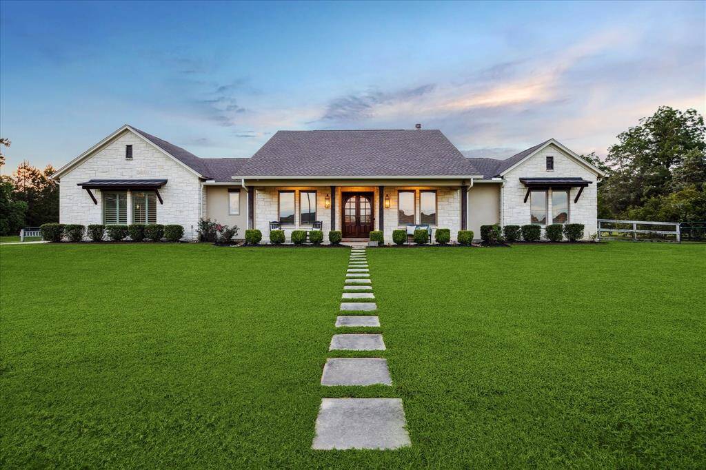 Welcome Home to 21319 Rosehill Church Dr. The twilight glow really showcases the home’s timeless stone exterior, front porch greeting, and peaceful setting.