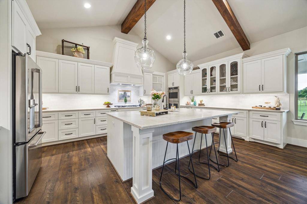 Custom cabinetry, dual ovens, and designer details make this kitchen a seamless blend of style and substance.