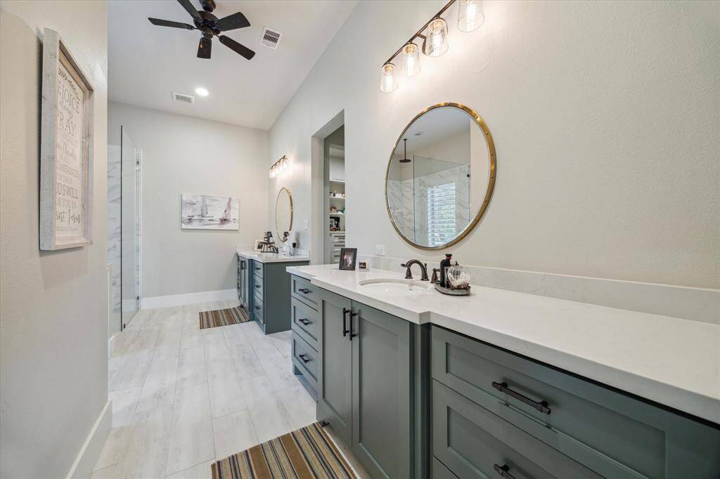 Thoughtfully designed en suite with double vanities, quartz counters, and a calm, restorative atmosphere.