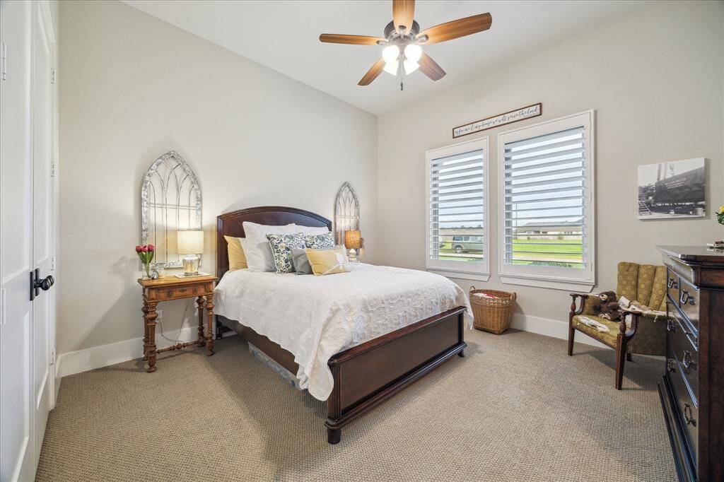 Elegant secondary bedroom with soft light, ample storage and floor space.