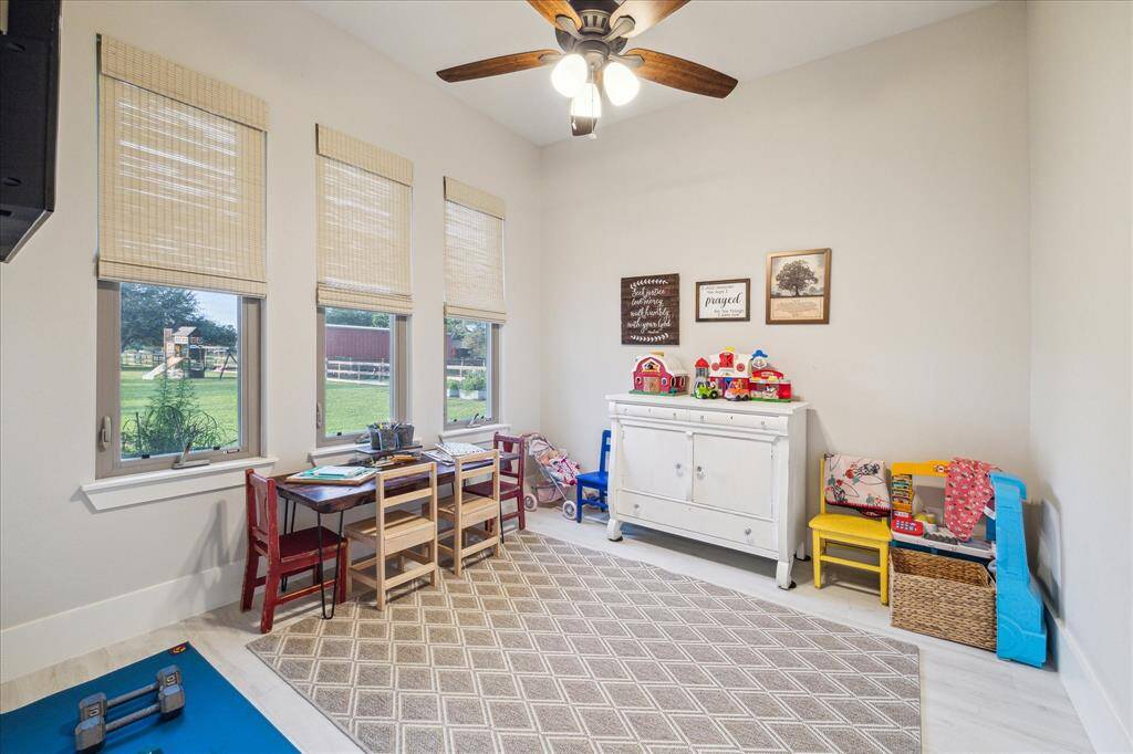 Light-filled flex room with serene views of the acreage - perfect as a playroom, creative space, or secondary office.